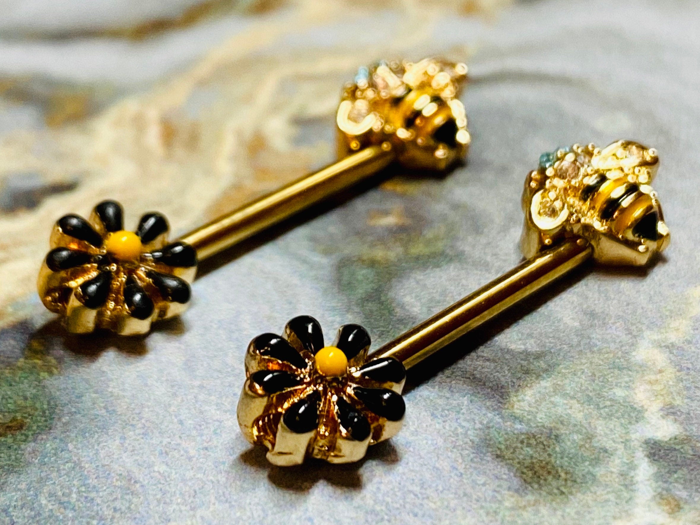 A set of Queen Bee Nipple Barbell.