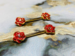 A set of Gold Red Rose Nipple Barbell