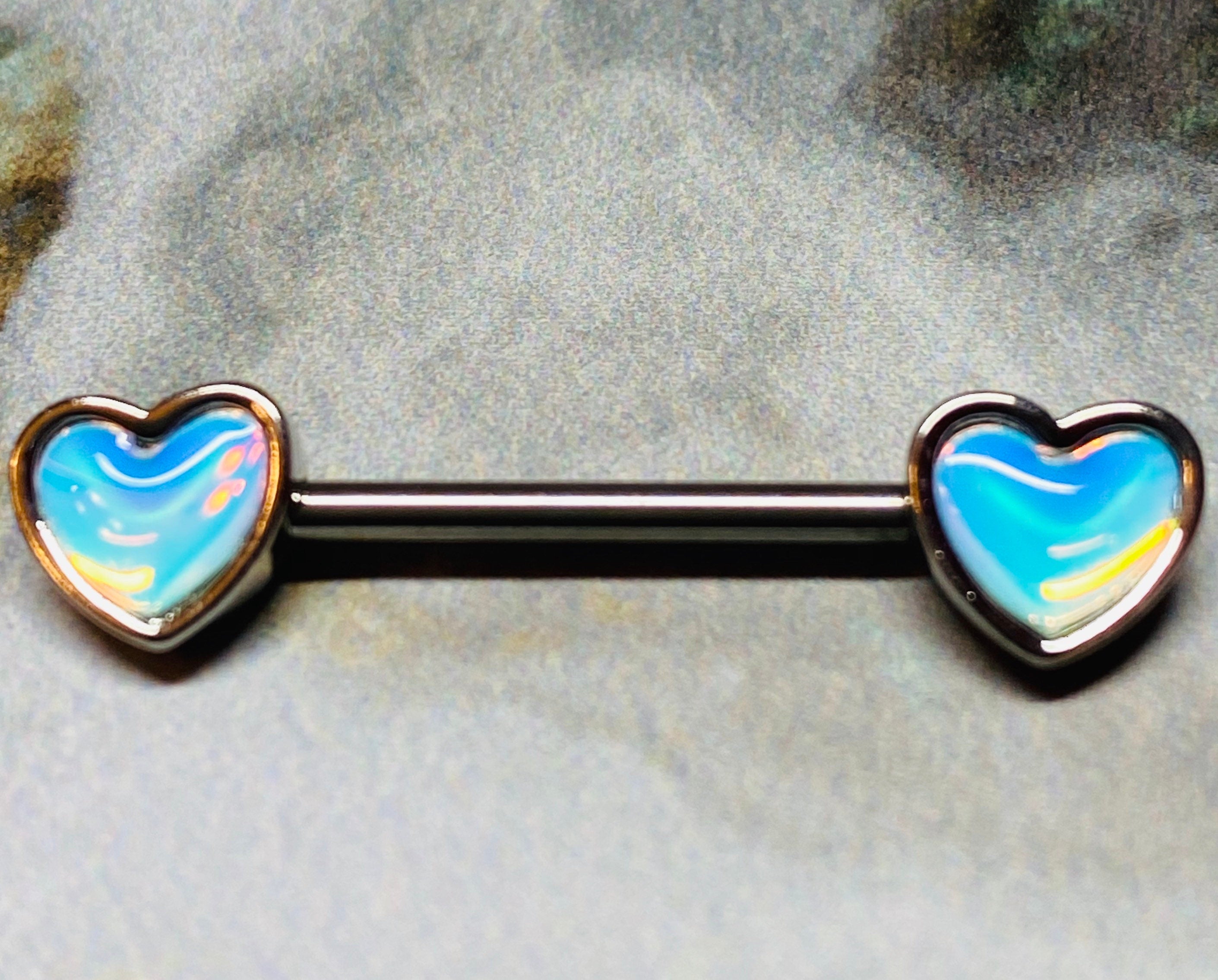 A set of illuminating Heart inlay Nipple Barbell