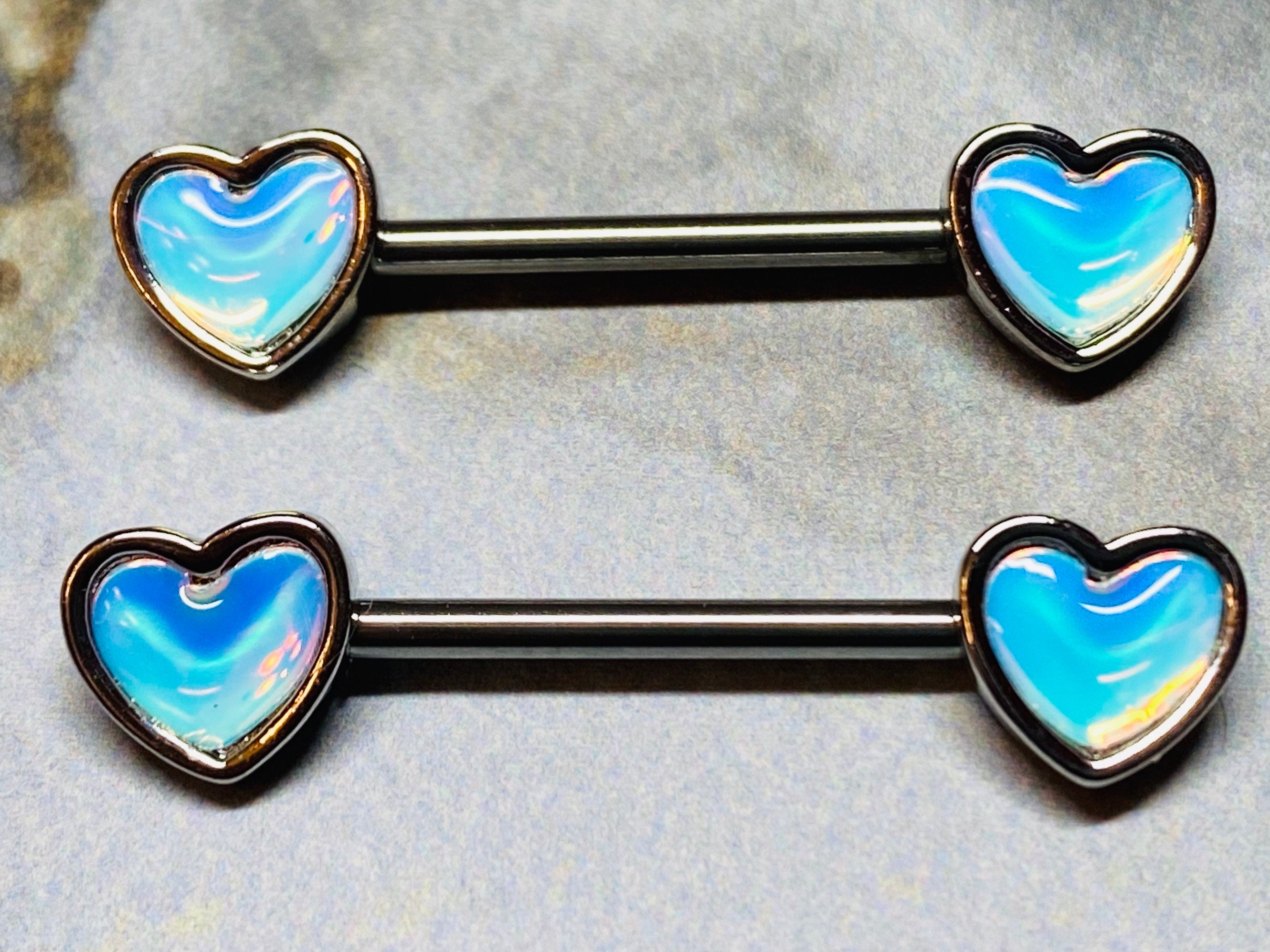 A set of illuminating Heart inlay Nipple Barbell