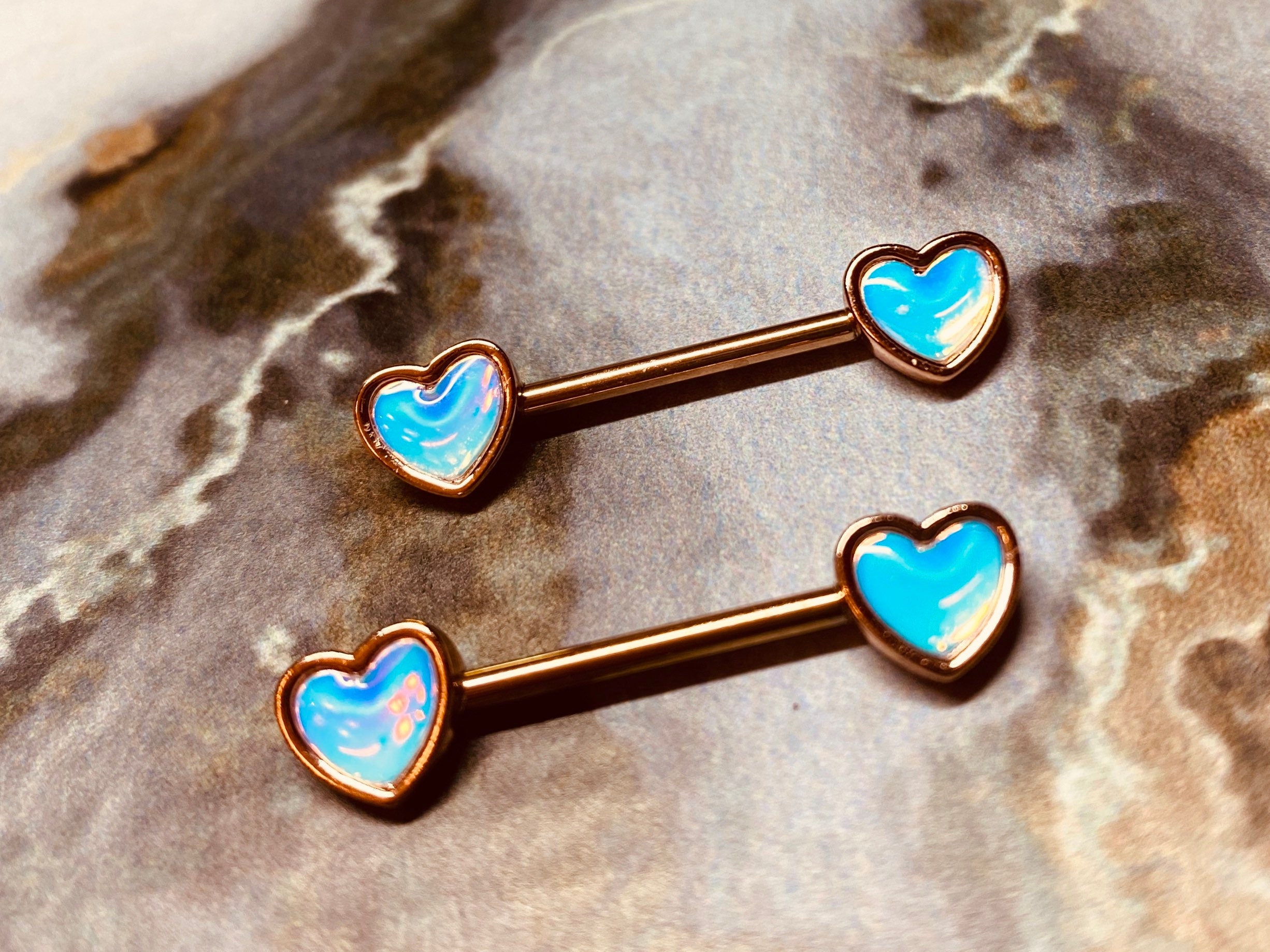 A set of Rose Gold Illuminating Heart Nipple Barbell