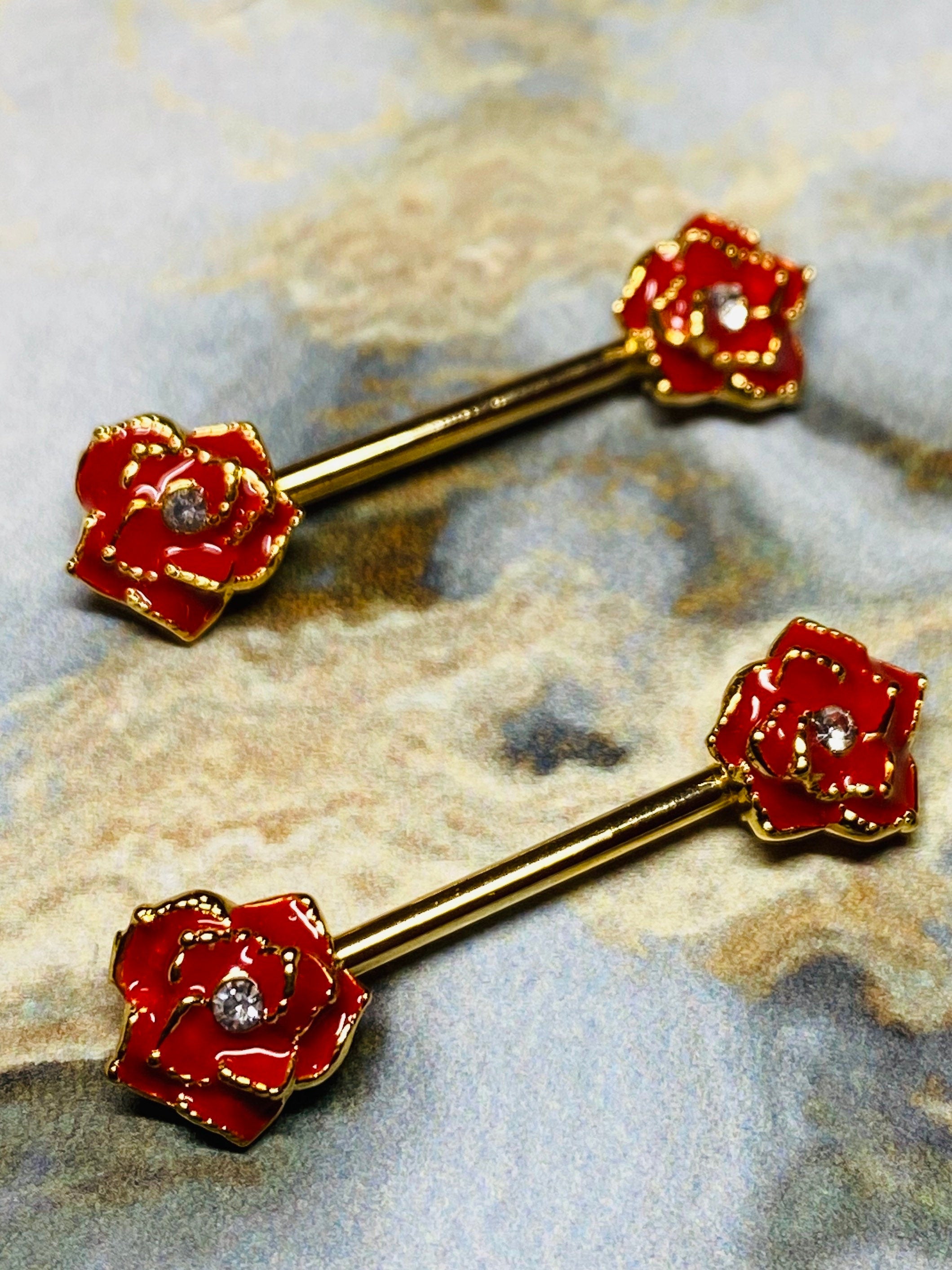 A set of Gold Red Rose Nipple Barbell