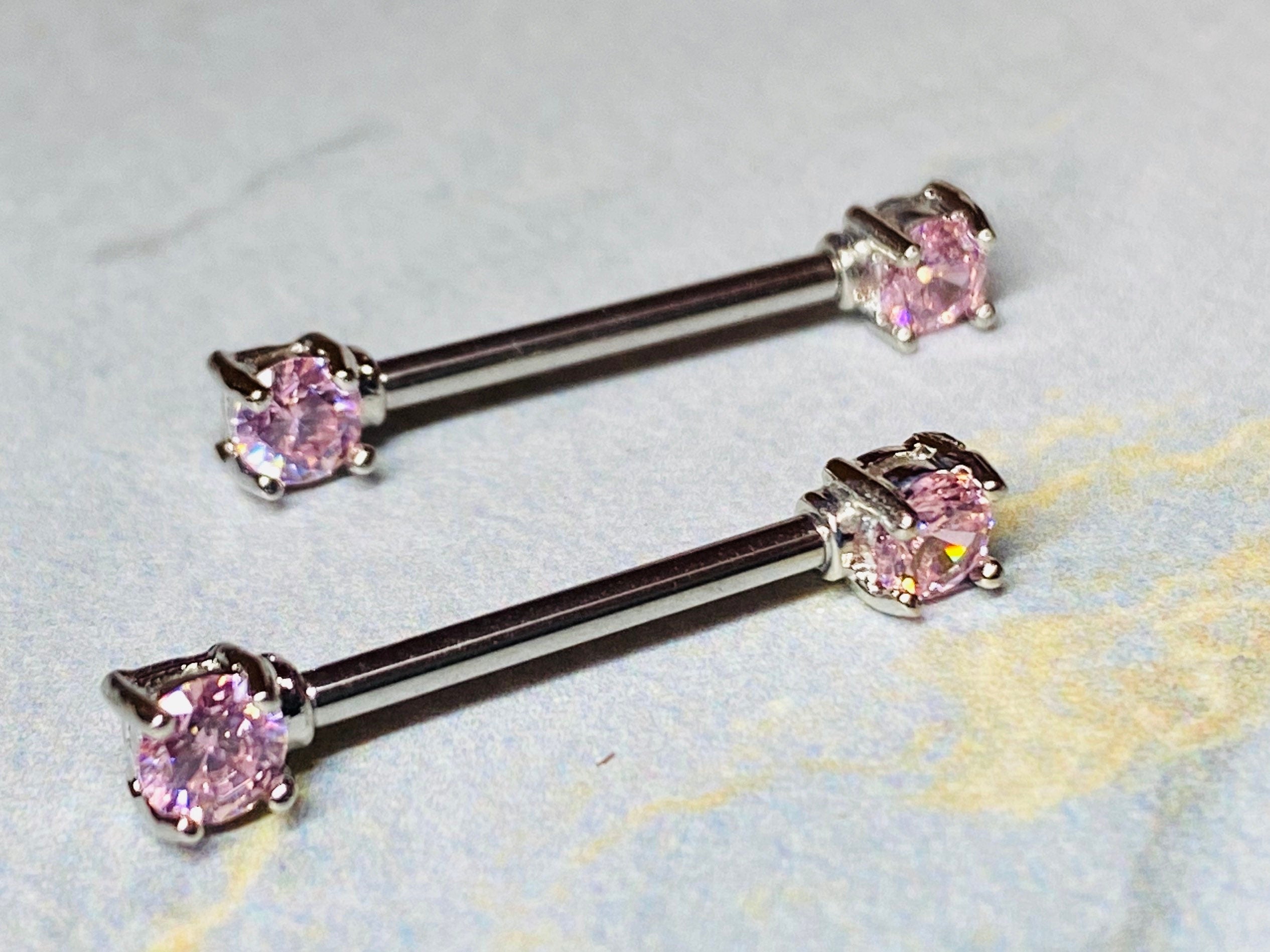 A set of Prong Set Pink 5mm Cubic Zirconia Nipple Barbell