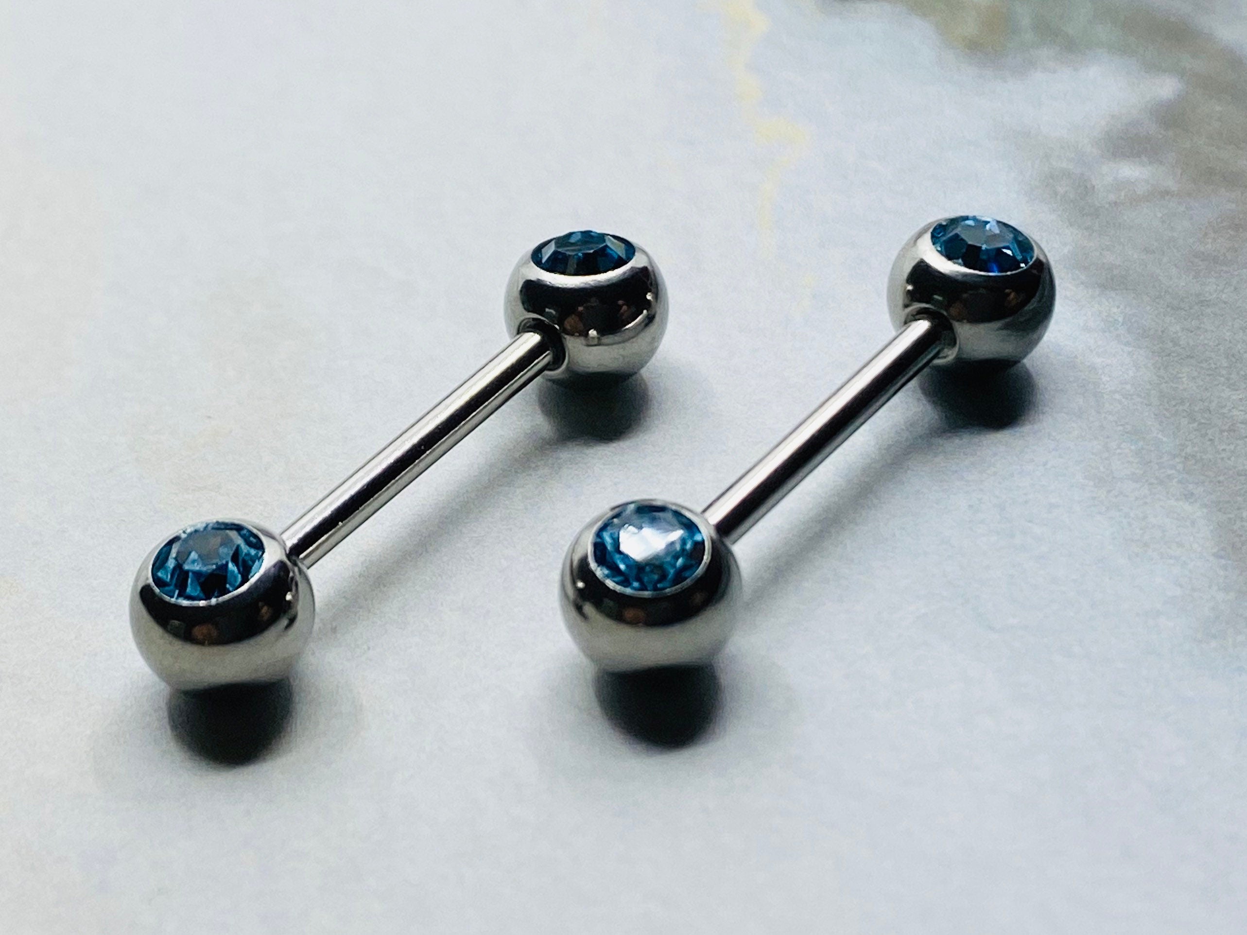 14G Front Facing Blue Crystals Nipple Barbells. Nipple Piercings. Nipple Rings. Nipple Jewelry.