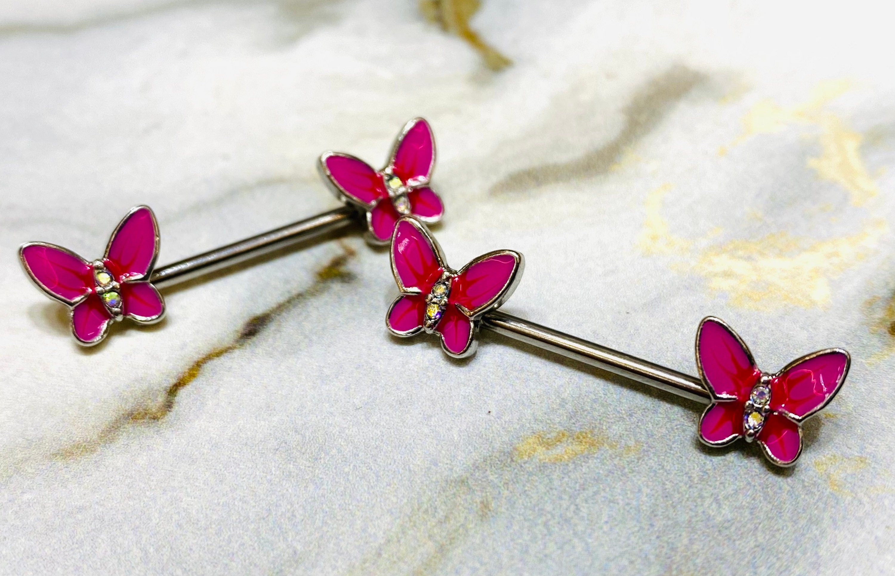 A pair of 14G Pink Butterly Ends Nipple Barbells. Nipple Jewelry. Nipple Piercing. Nipple Rings.