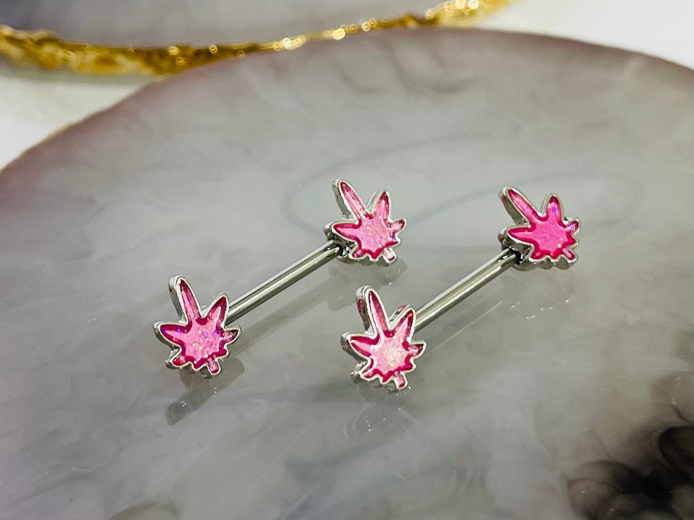 Pair of 14G Silver Pink Glitter Marijuana Leaf Nipple Barbell.