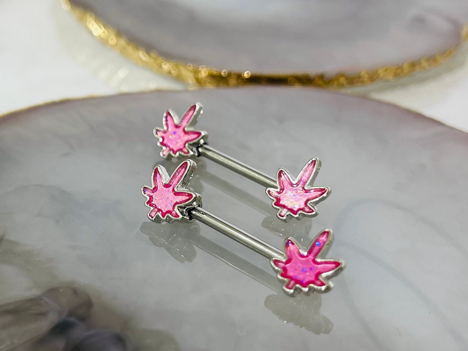 Pair of 14G Silver Pink Glitter Marijuana Leaf Nipple Barbell.