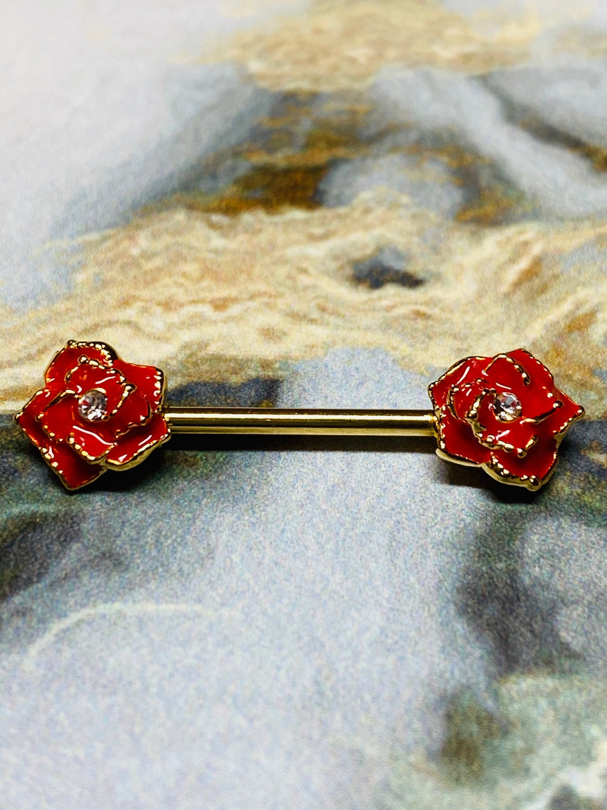 A set of Gold Red Rose Nipple Barbell