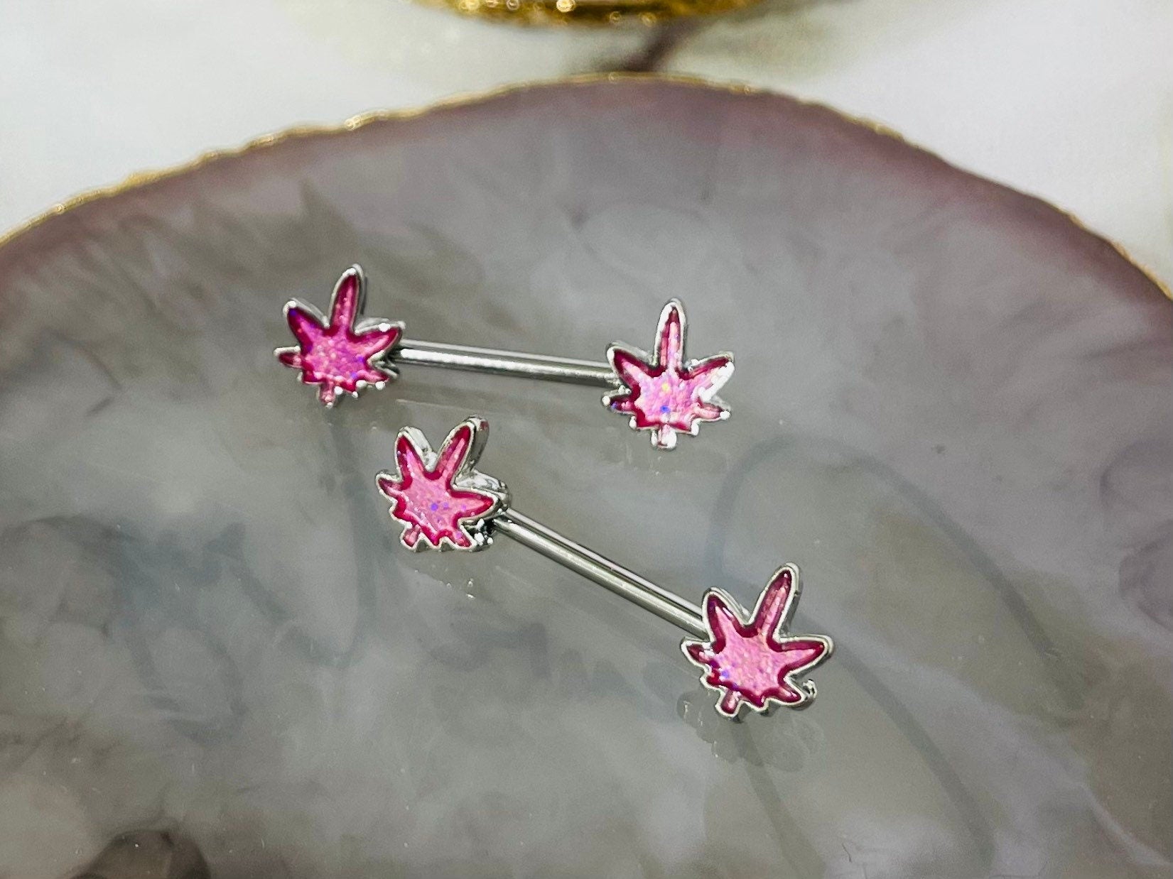 Pair of 14G Silver Pink Glitter Marijuana Leaf Nipple Barbell.